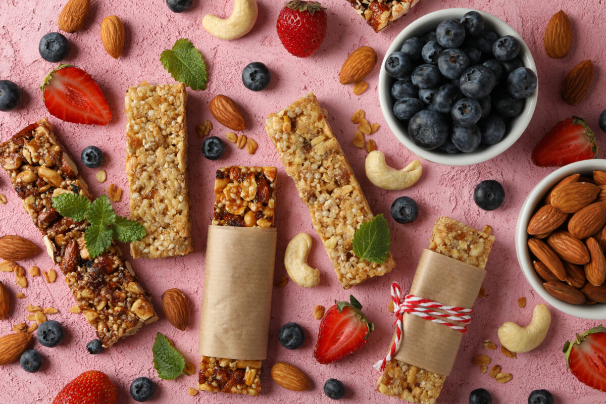 granola bars, fruits and nuts spread out on a table